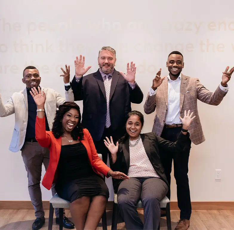 Five professionals posing together at a SkillHat founder studio session